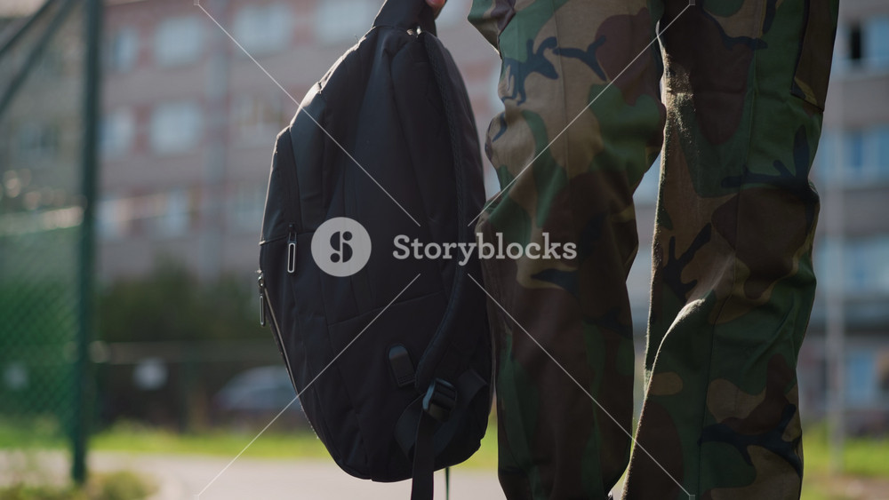 Soldier With Bag, Quiet Soldier Departs On City Sidewalk, Solitary Military Figure Embraces Calm Urban Environment Farewell, Lone Serviceman