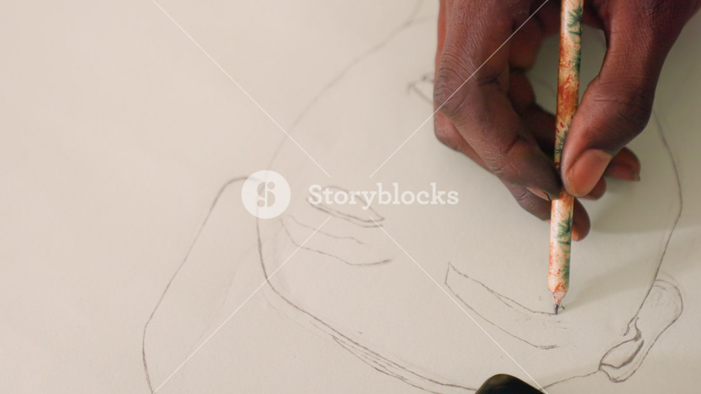 Refining features with precise strokes. Closeup of artist shaping facial contours carefully. Artist meticulously enhancing mouth and chin