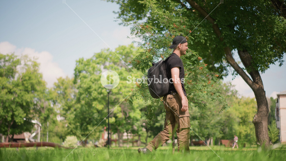 Solo Male Strolling Through Sunlit Park, Casual Male Artist Contemplating Amidst Lush Green Surroundings, Independent Male Creator Taking