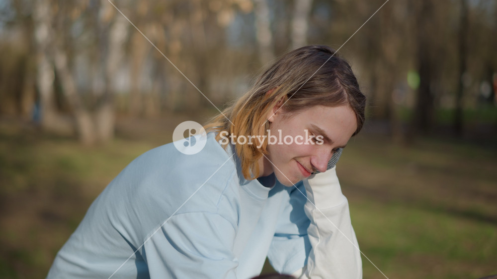 friendly park encounter, young male shows kindness to small dog, casual scene of friendship between boys and pet outdoors, teenage boys
