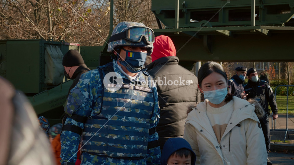 Bucharest, Romania - 1 December, 2024: Romania National Day. Soldat make photo with asiatic people. Army, special forces, soldiers, military parad. The Great Union day