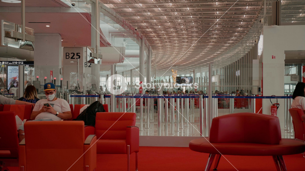 PARIS, FRANCE - July 2024: Man at international airport waiting for flight at terminal. Travelling people on the Background.