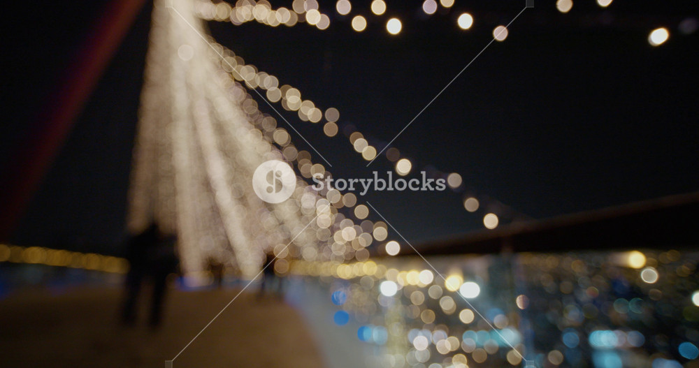 Holiday background with bridge in parck at the Christmas market. Out of focus holiday background. Light bokeh from Xmas tree. New Year theme, background.
