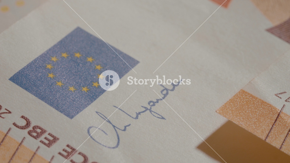 The banknote shows intricate designs, including the European flag and various security features. It highlights the importance of the euro in financial transactions across Europe.