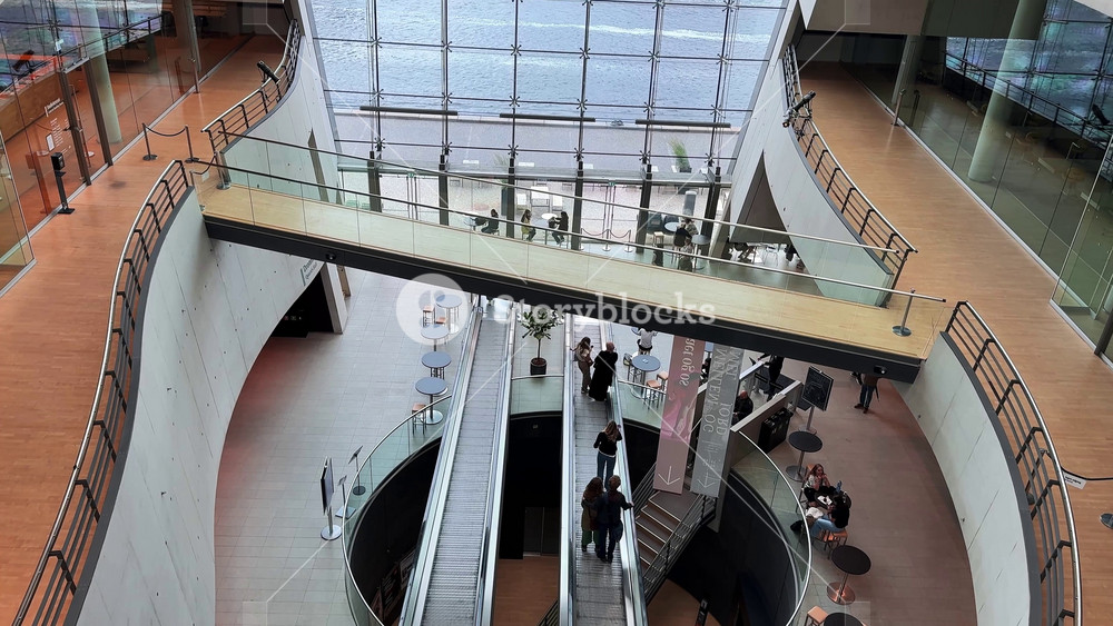 The video captures the modern design of the Royal Danish Library in Copenhagen, with curved walkways, glass walls, and a slow pan of the atrium.