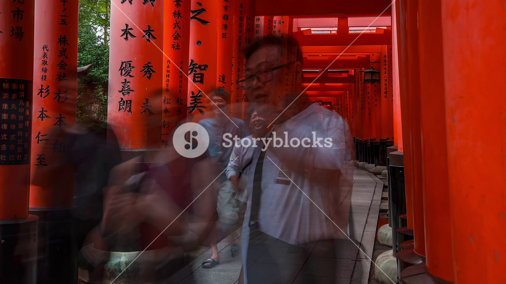 Timelapse of the red Torii gates, Fushimi Inari Taisha Shrine in Kyoto in Japan, Chinese character in this picture means - dedication.