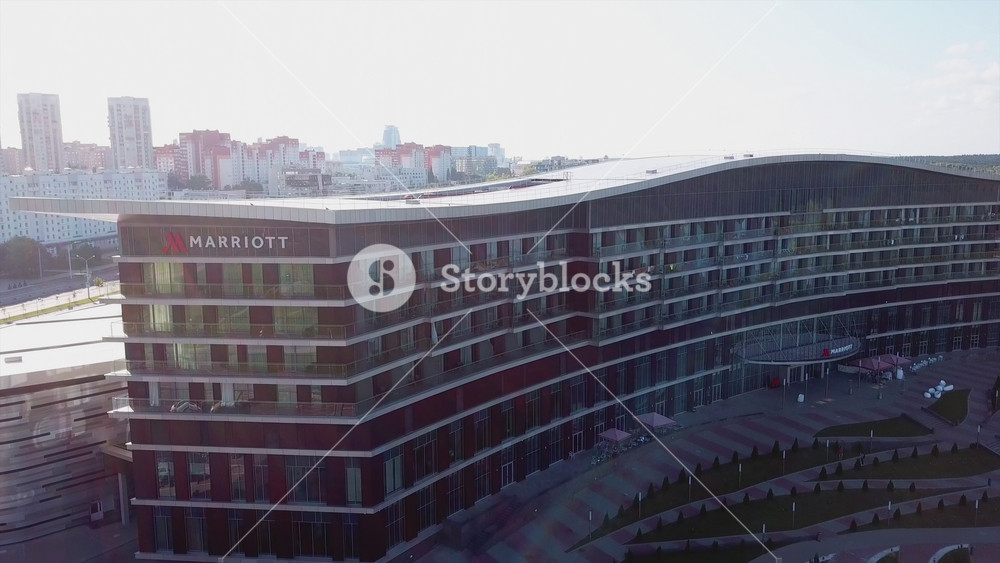 Minsk, Belarus - August, 2019: modern architecture, aerial view beautiful Marriott hotel in city center. Top view panorama, cityscape, residential and business buildings, traffic in the streets