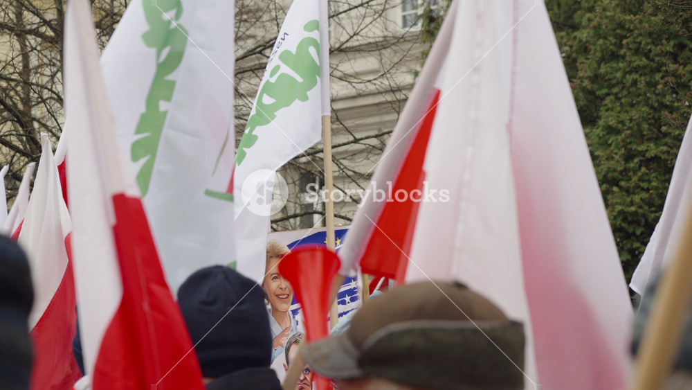 Warsaw, Poland - March 6, 2024: group of people carrying red and white flags on the street, farmers protest, demonstration of protesting agricultural workers, people crowd marching