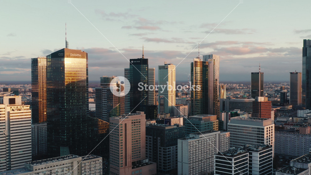 Warsaw, Poland - 20.09.2023: Drone shot cityscape, establishing aerial view urban skyline cinematic city downtown, high rise office skyscrapers modern architecture buildings in sunrise light