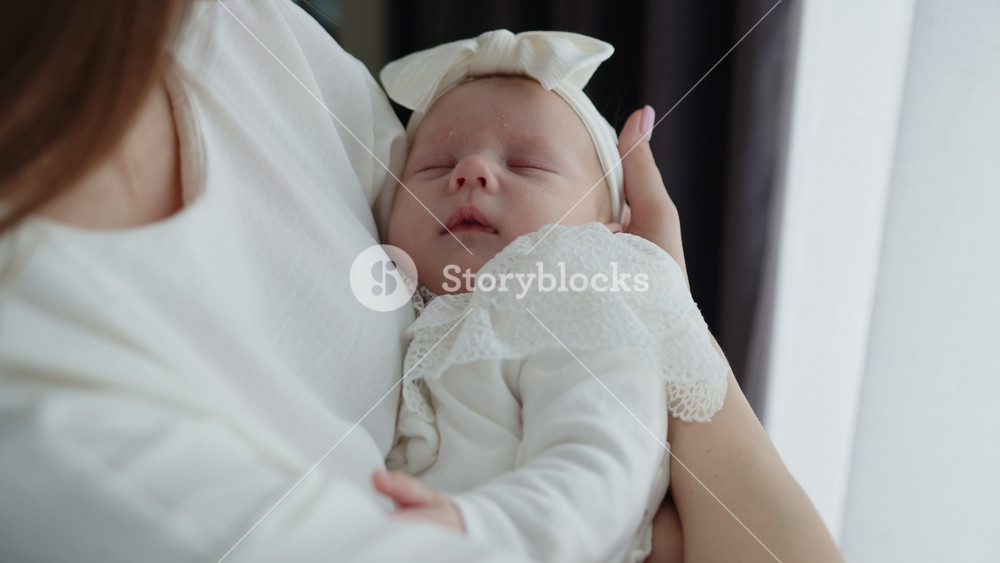 Mother Holding Sleeping Newborn Baby. Mother Holding Newborn Baby. Tender embrace pastel balloons lace outfit festive warmth