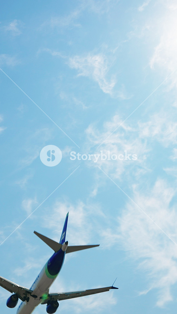 Low Angle Vertical Airplane Orange Engines Landing Gear Blue Sky Clouds Slow Motion Spain Aviation Travel Tourism Freedom Movement Portrait Instagram Reels TikTok Background Concept