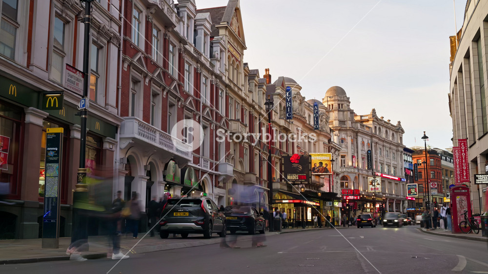 London, England - May 14, 2025: Time lapse of a lively street with cars and double-decker buses and colourful lights in the evening