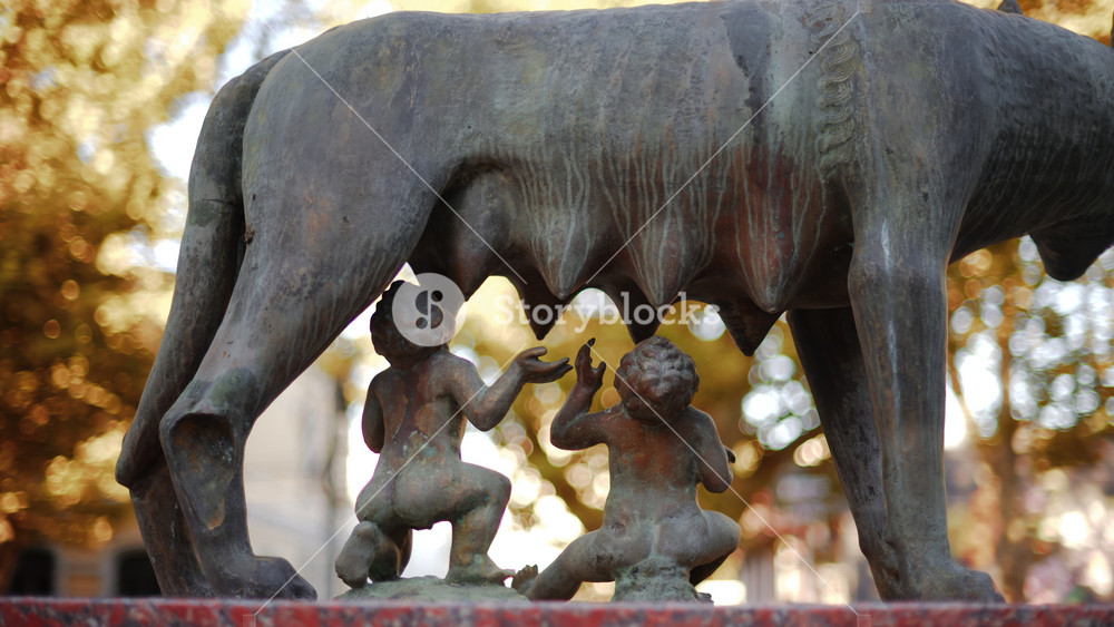 Chisinau, Moldova - September 25, 2025: Historic bronze statue of the Capitoline Wolf with Romulus and Remus on a red marble pedestal in front of the National History Museum of Moldova