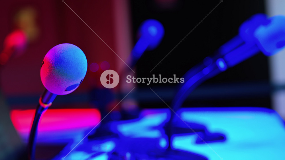 Close up of a microphone on a blurred background with blue and red lights at the International Games Festival in Cannes, France