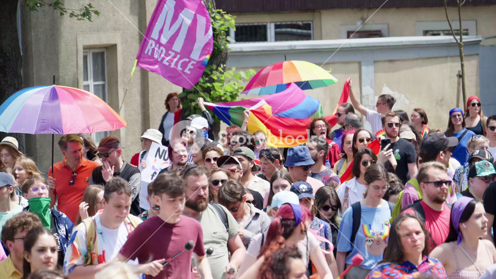 Chisinau, Moldova - June 15, 2025: People marching, holding signs and rainbow umbrellas at the Pride Parade in the city center
