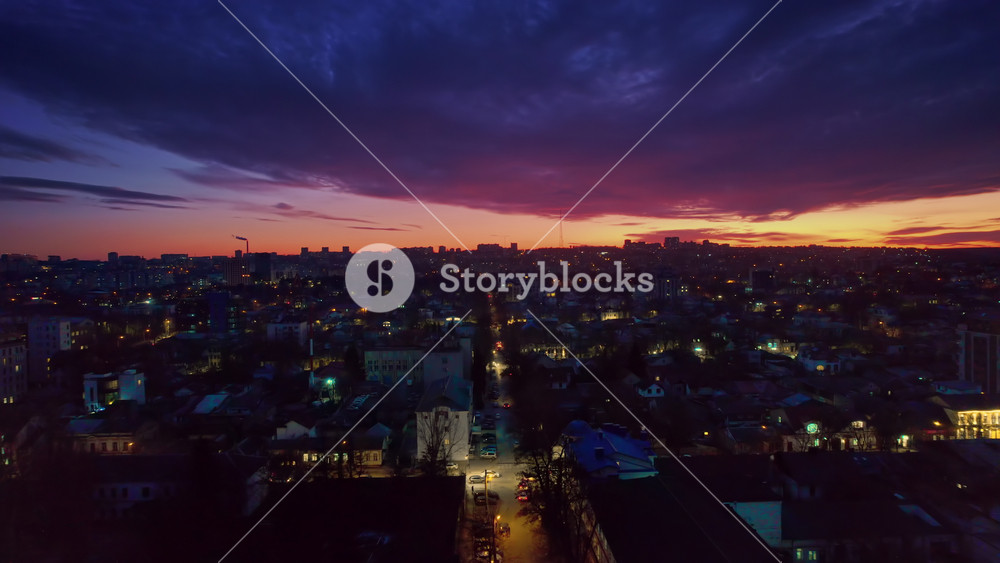 Aerial drone view of Chisinau at sunset, Moldova. View of the city with multiple buildings, roads with illumination
