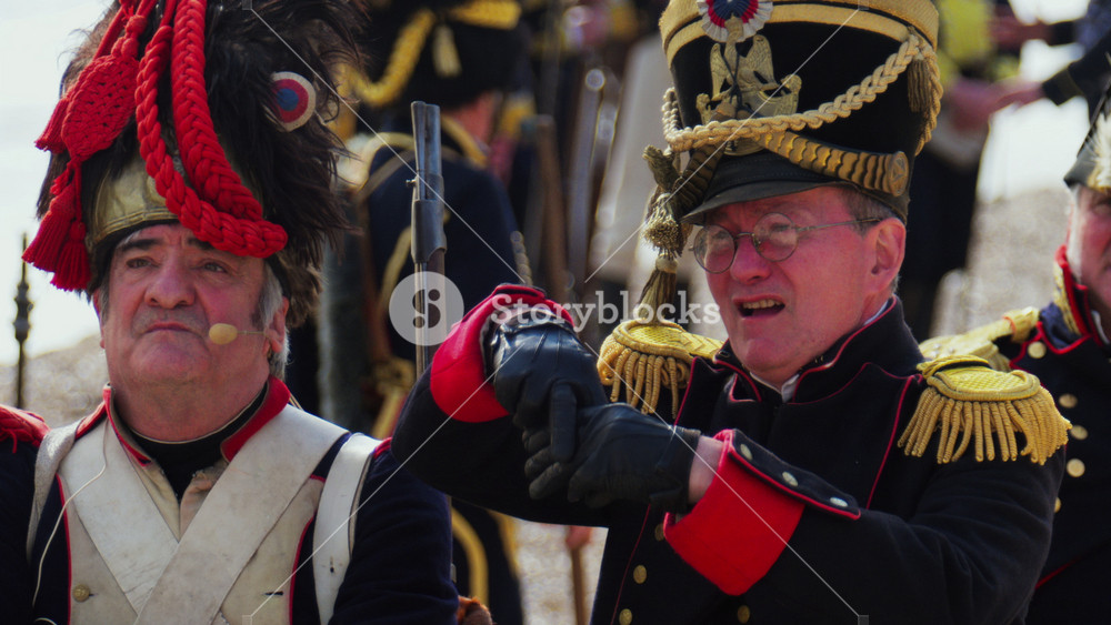 Golfe Juan, France - March 1, 2025: Men talking, dressed up in costumes, re-enacting the landing of Napoleon Bonaparte on the beach
