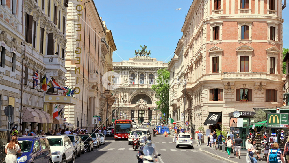 ROME, ITALY - JUNE, 2022: Street scape of the centre of the city. Street with greenery, moving cars and walking people, buildings made in classic style