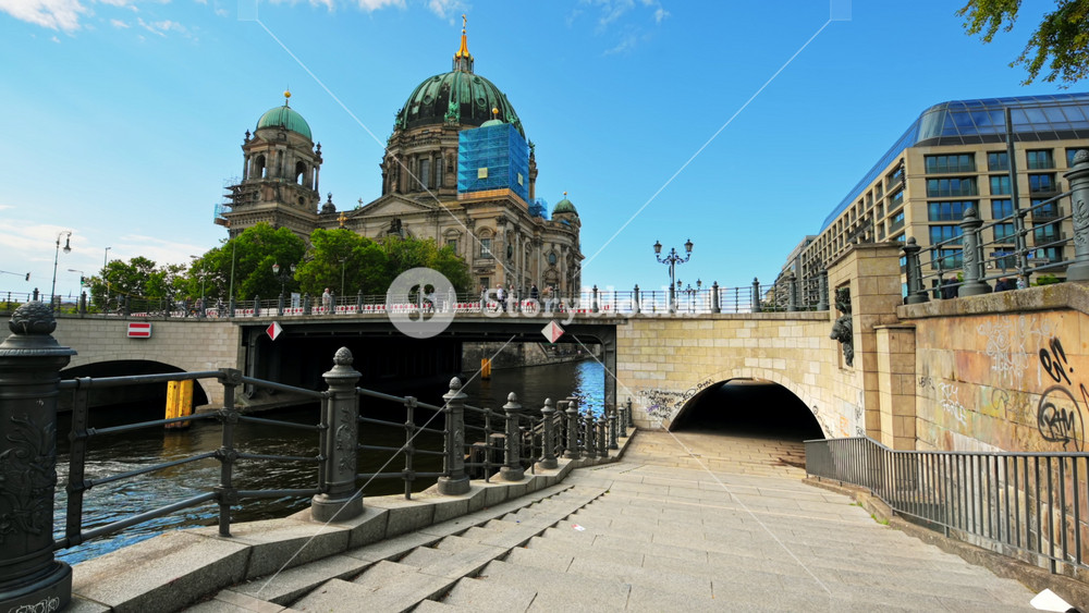 BERLIN, GERMANY - SEPTEMBER, 2022: View of city downtown. Cathedral, Liebknecht Bridge over the Spree river, walking people and moving cars