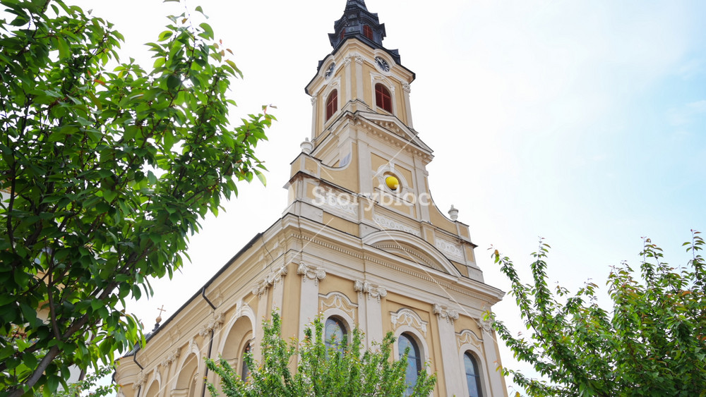 ORADEA, ROMANIA - MAY 22, 2023: View of the Moon Church located on the Unirii Square in city downtown. Square with people in front of it