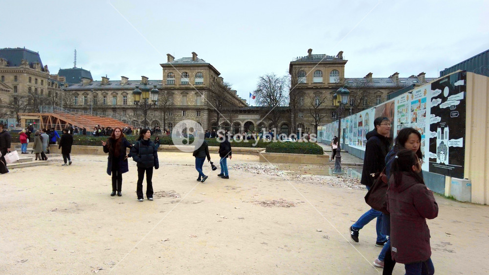 PARIS, FRANCE - DECEMBER 24, 2022: View of the square in front of the Notre-Dame de Paris in city downtown, walking people