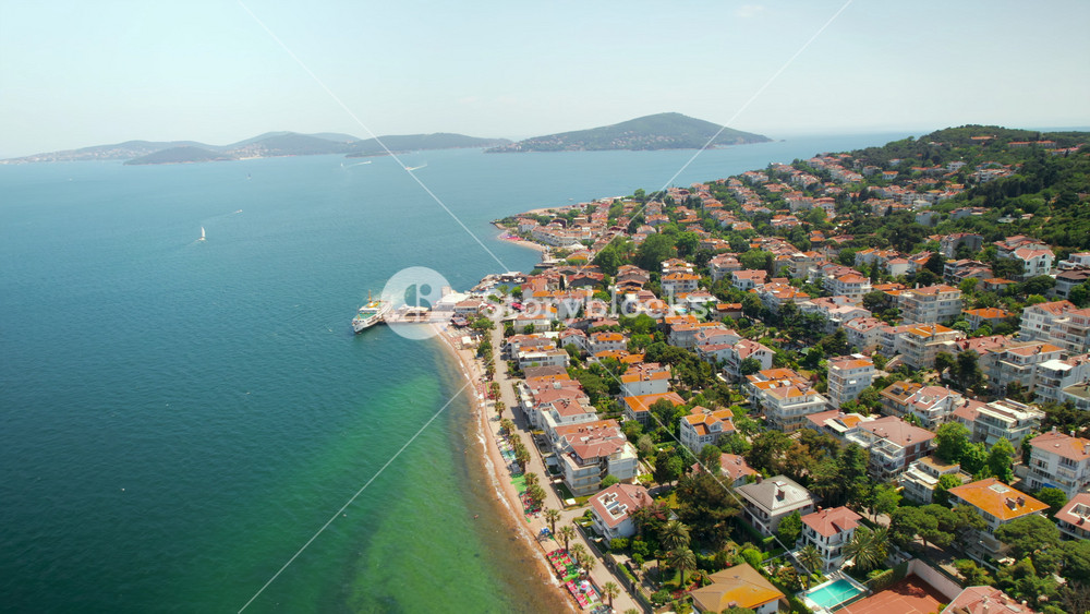 Aerial drone view of Kinaliada, Turkey. Multiple residential buildings located on the shore of Marmara sea, other Princes Islands on the background