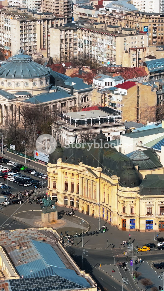 Bucharest, Romania - March 03, 2024: Vertical aerial drone view of Carol I University Foundation. Main building with Carol I statue in front of it, roads and buildings