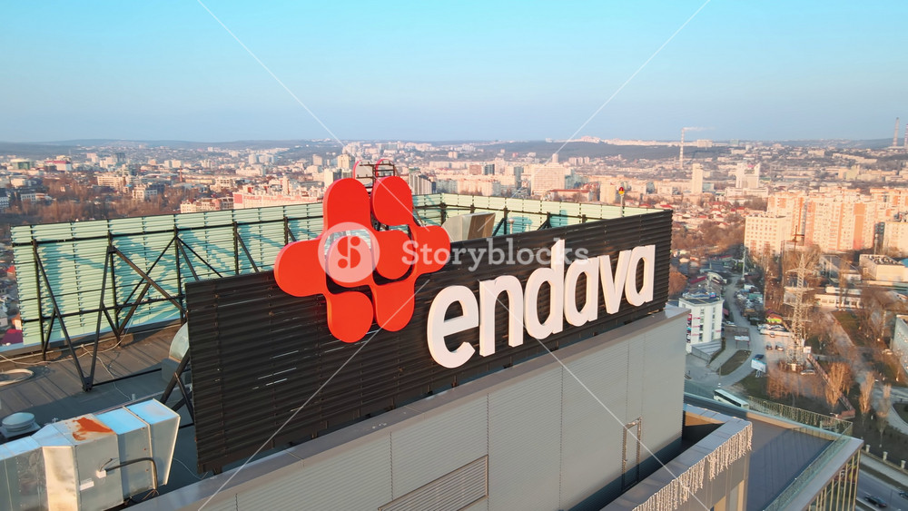 CHISINAU, MOLDOVA - JANUARY 17, 2021: Aerial drone view of a modern office building with Endava logo on the roof. Cityscape on the background