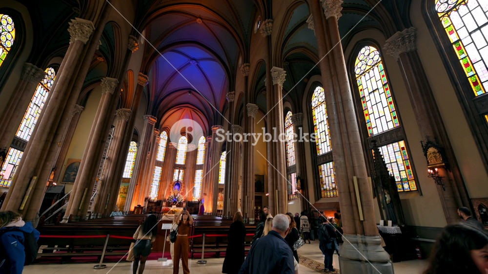 ISTANBUL, TURKEY - MAY 19, 2023: Interior view of the Church of Saint Anthony of Padua. People, stained glass windows, the altar