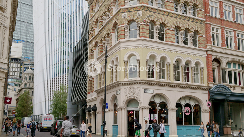 LONDON, UNITED KINGDOM - SEPTEMBER 12, 2023: View of the Sky Garden skyscraper in the City district with classic buildings, moving cars and people in front of it