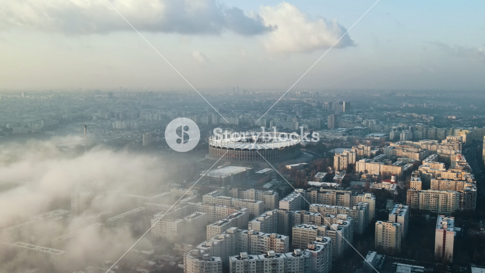 Cityscape of Bucharest from a drone, rows of residential buildings, thermal station with fog getting out and other the ground, ecology idea, Romania