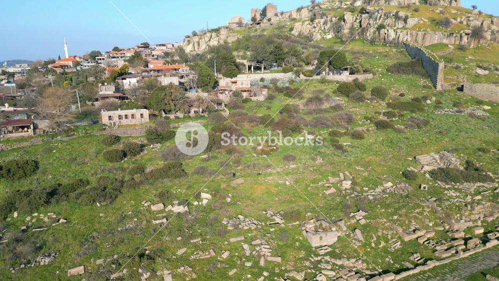 Aerial view of the ancient Temple of Athena ruins on the acropolis of Assos (Behramkale) over the Aegean Sea in Canakkale, Turkey. 4K