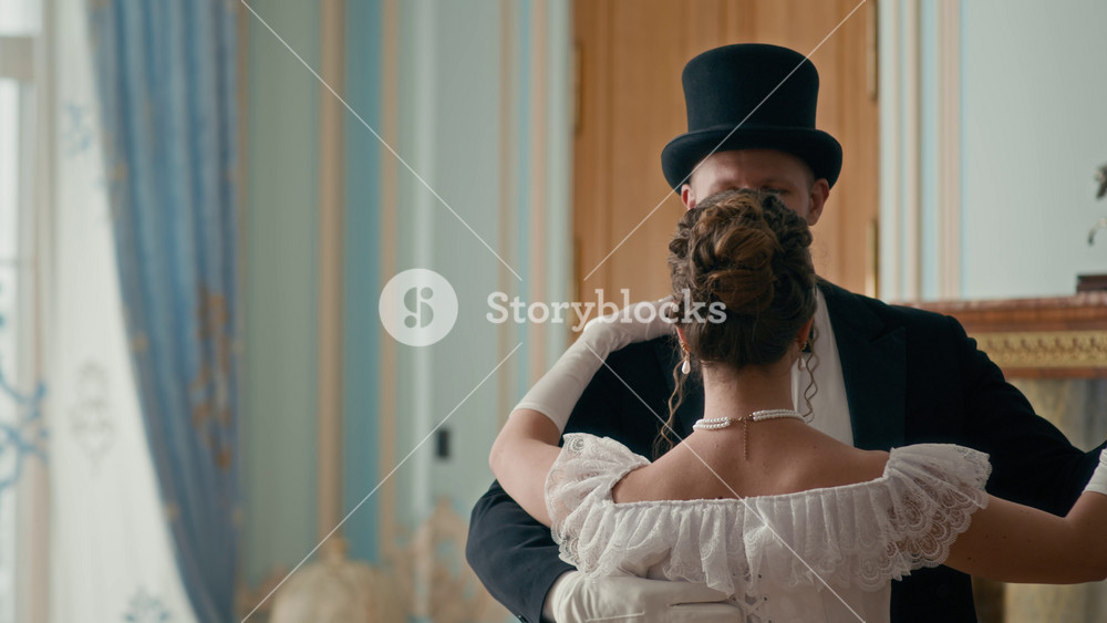 Smiling aristocratic lady in white vintage dress dancing gracefully with gentleman in formal attire and top hat in refined room featuring light blue walls and golden accents