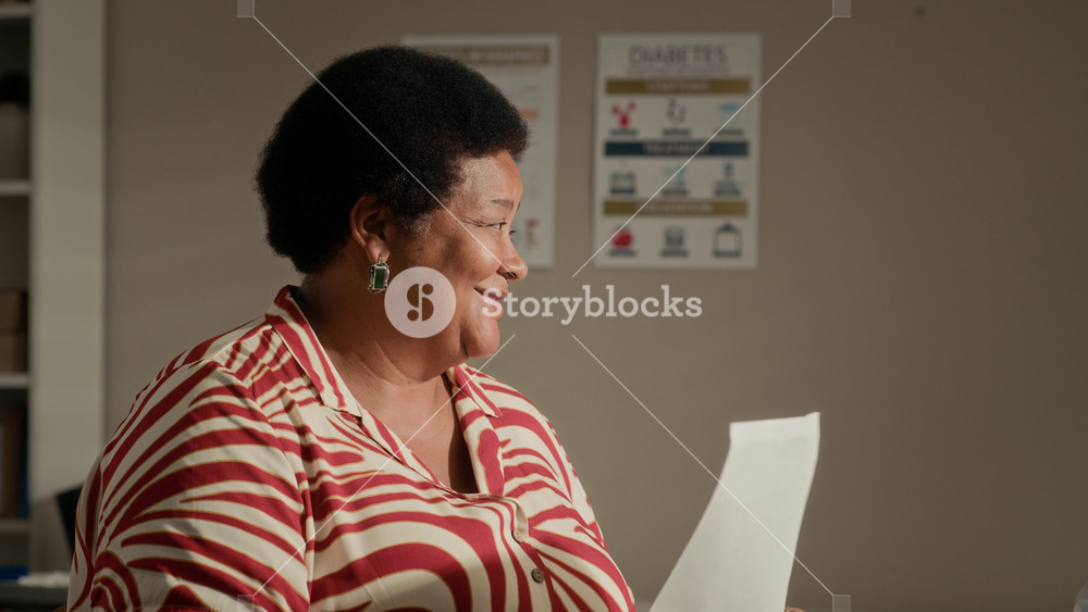 Medium closeup of Black senior woman with diabetes receiving medical recommendations from Middle Eastern doctor and expressing gratitude in clinic office