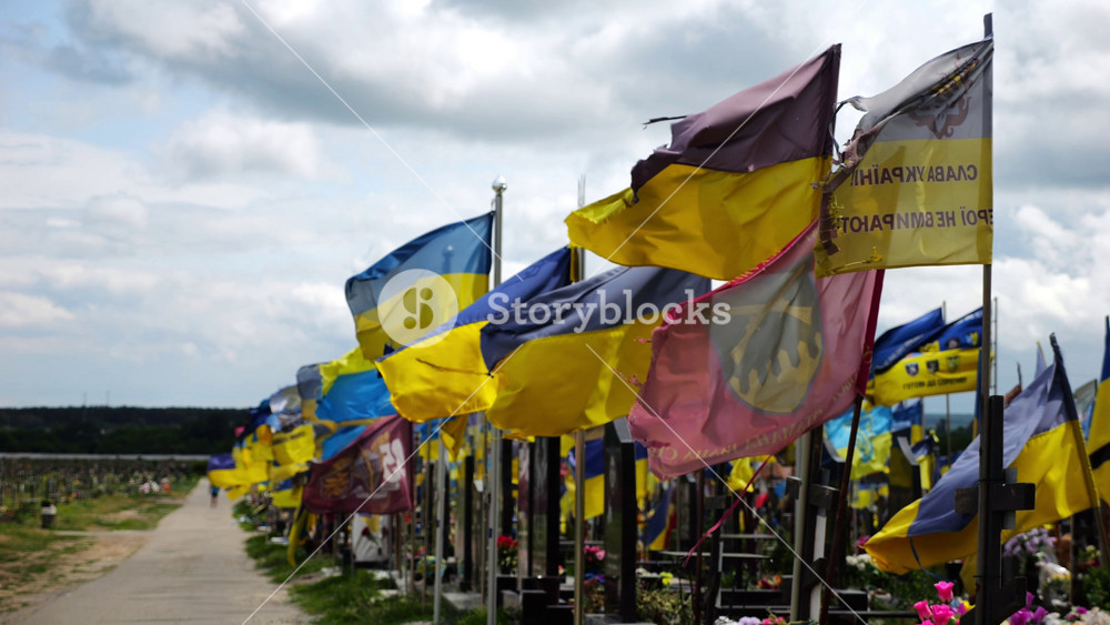 View on blue-yellow flags at countless graves of ukrainian soldiers alley of glory in Kharkiv. This site commemorates heroes and maintains