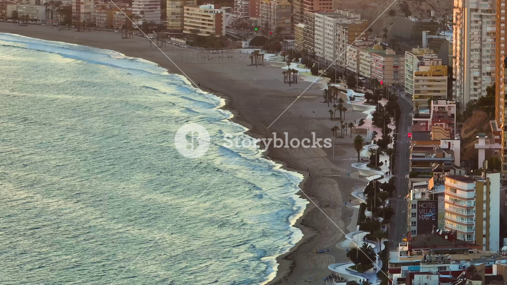 Aerial view of the beautiful city of Benidorm in Spain showing the Playa de Levante beach and the high rise apartments and hotels in the city at sunset