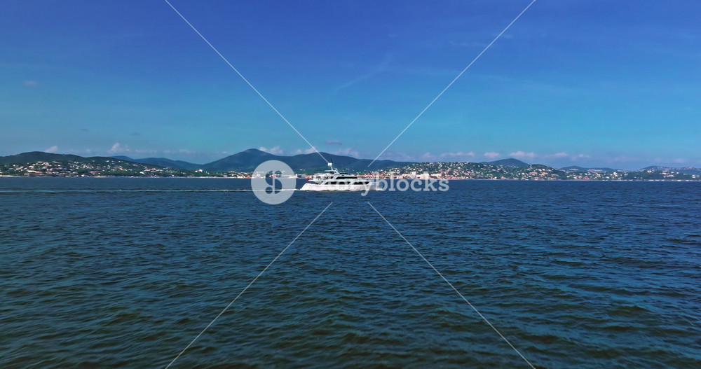 Aerial view tracking of beautiful modern white superyacht. Lifestyle luxury boat sailboat establishing aerial drone. Motor yacht in motion