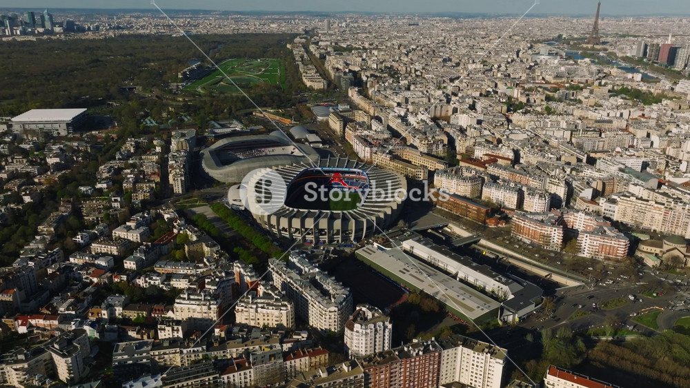 Aerial drone distant sunset view of Tour Eiffel Tower and Seine River bridge traffic cars driving, Paris city attractions, France
