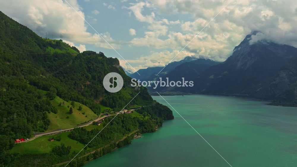 Water transport in Switzerland. Navigating a Swiss Lake. Aerial view steamboat ship on lake Interlaken. Switzerland summer tourism destination. Turquoise blue water. Swiss flag on a passenger ship