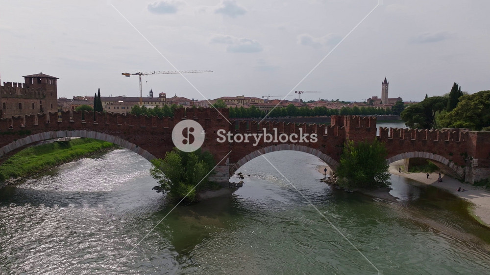 Aerial Drone View of Castelvecchio Bridge (Ponte di Castelvecchio) over Adige River in Verona, Italy Historic Medieval Fortified Bridge and Scenic Cityscape