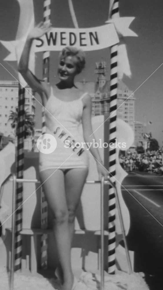 1957 - Miss Sweden, Miss Italy, Miss Austria, Miss Germany, and Miss Canada wave from their individual parade floats in Long Beach, California before the Miss Universe pageant is set to begin.