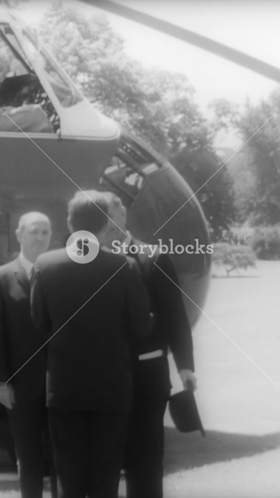 1961 - LBJ and Lady Bird Johnson arrive at the White House via helicopter and meet with JFK to discuss their diplomatic tour of southeast Asia.