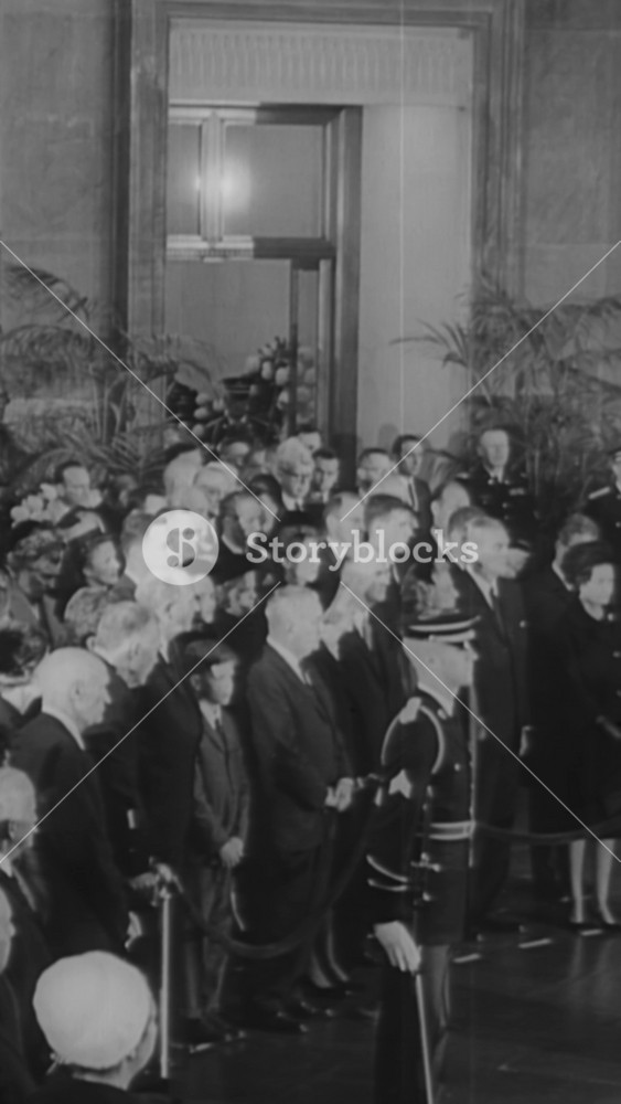 1964 - An obituary for President Hoover shows his inauguration, and mourners visiting his coffin in the rotunda of the Capitol Building in Washington DC.