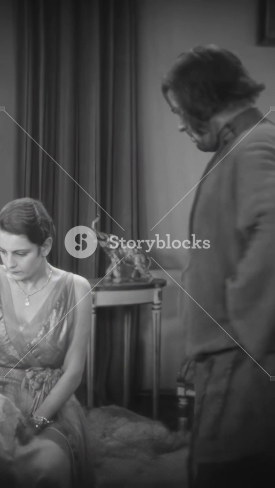 RUSSIA - 1927 - in this silent drama, a rebellious peasant roughly orders an aristocrat to sit down. He demands her to kiss him but she coldly tells him to go back downstairs where he belongs.