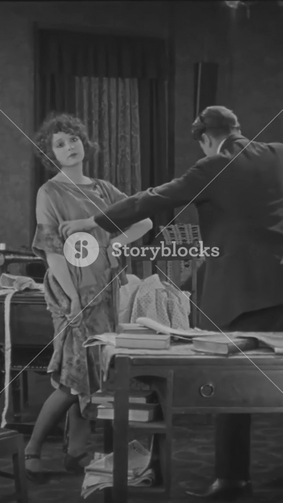 1924 - in this silent drama, a French woman and an American man are rehearsing a scene at home. At the end of the scene, he walks away slowly. She runs after him, grabs him from behind, and they hug lovingly.