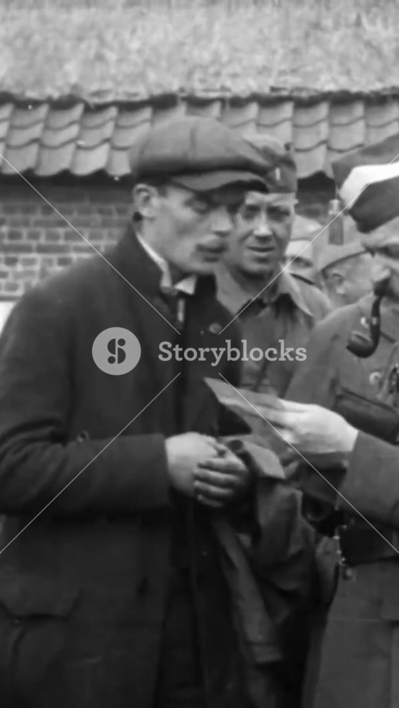 1918 - Happy children swarm the soldiers who've liberated their city of Ypres, Belgium, and an officer reads a man's letter.