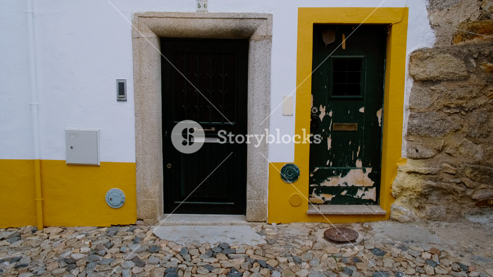 EVORA, Portugal, circa 2022 - Discovering the narrow and picturesque streets of Evora, Portugal, featuring the famous whitewashed houses with yellow accents