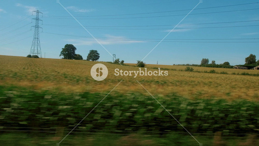 Passenger view of amazing croplands and rolling hills in the Cotswolds in England, UK, an Area of Outstanding Natural Beauty with 787 square miles, the second largest protected landscape in England