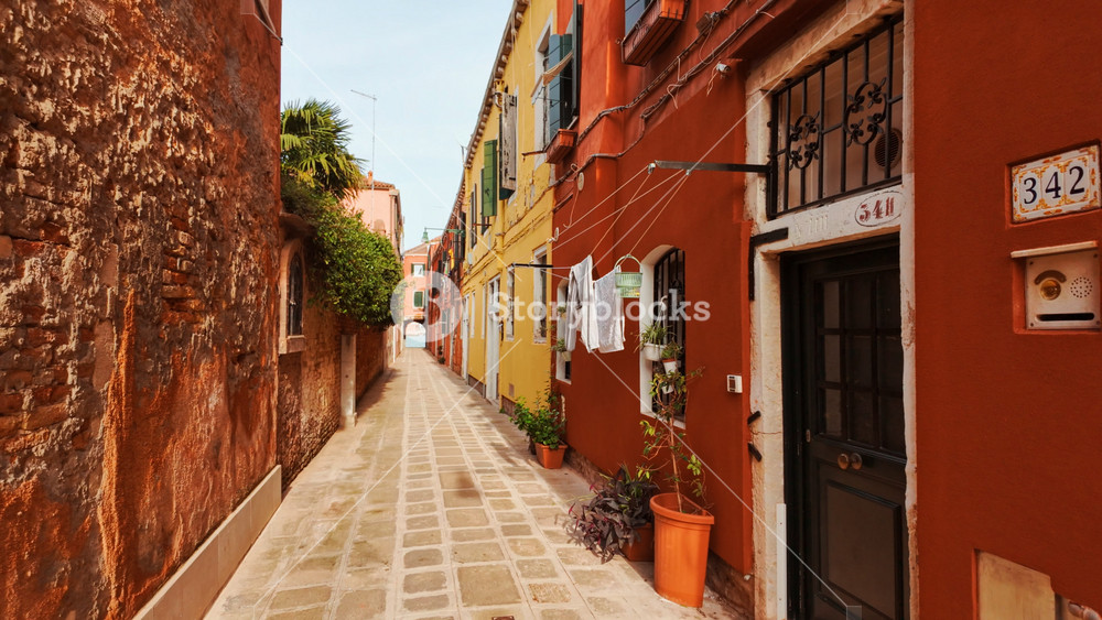 Walking along the narrow streets of the Jewish ghetto in Cannaregio, Venice, Italy. Venice is an archipelago of 126 islands linked by 472 bridges