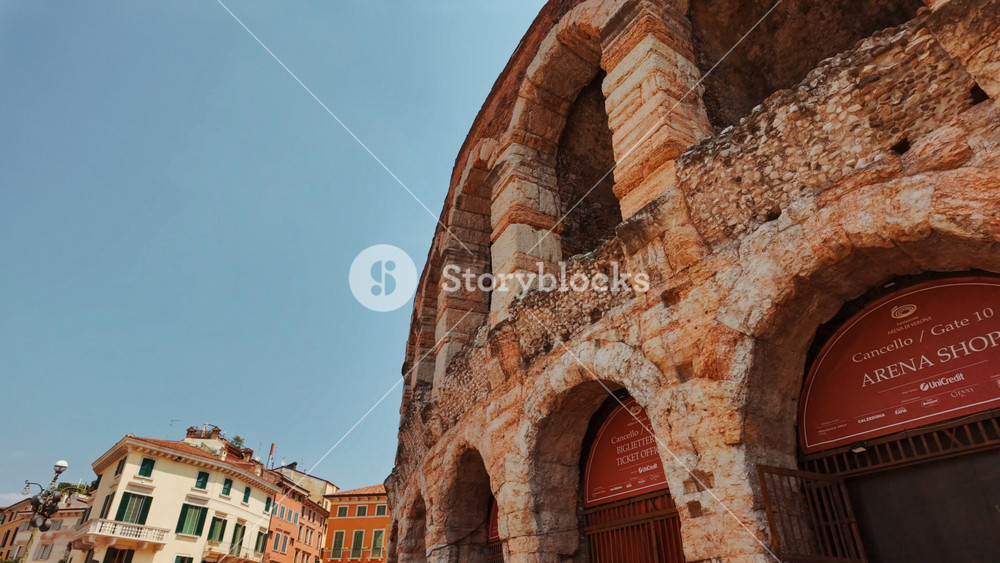 VERONA, Italy, 12 JULY 2024 - Exterior view of the oval Roman arena framed by shadowed corridors and textured stonework, Verona, Veneto, Italy